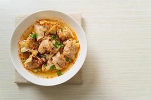 pork wonton soup or pork dumplings soup with roasted chili photo