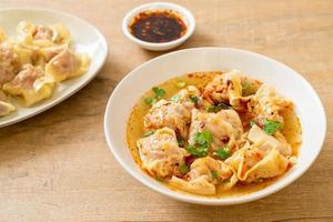 pork wonton soup or pork dumplings soup with roasted chili photo