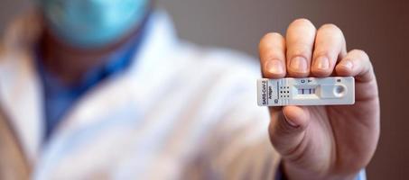 Positive test result by using rapid test device for COVID-19. photo