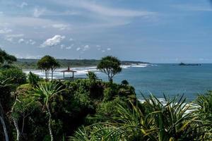 Natural view of the coast in Indonesia when the weather is sunny. Karang Tawulan beach tourism in Indonesia photo