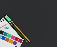 school supplies with watercolor and paintbrush on table background photo