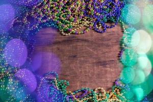 Mardi Gras border of beads with bokeh with copy space photo