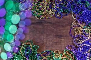 Mardi Gras border of beads with bokeh with copy space photo