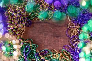 Mardi Gras border of beads with bokeh with copy space photo