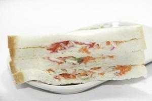 Healthy ham sandwich with cheese, tomato - lettuce - corn - carrot on white background. photo