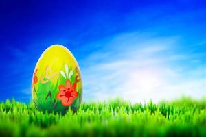 Hand painted Easter egg on grass. Spring patterns art, unique. photo