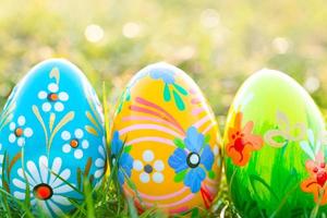 Handmade Easter eggs on grass. Spring patterns art, unique. photo