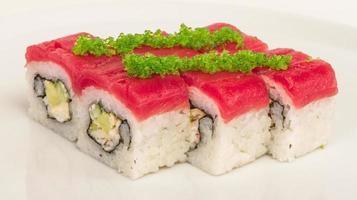 Maki Sushi - Roll made of Crab, avocado, cucumber inside. Fresh Tuna and tobico roe outside photo