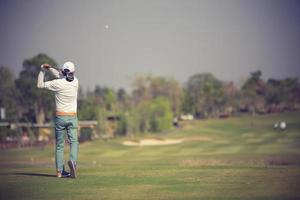 Golfers hit sweeping golf course in the summer.Vintage color photo