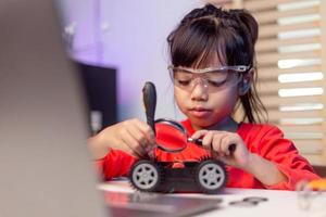 Asia students learn at home in coding robot cars and electronic board cables in STEM, STEAM, mathematics engineering science technology computer code in robotics for kids concept. photo