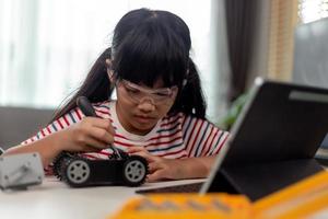 Female Student Building And Programing Robot Vehicle In After School Computer Coding Class photo