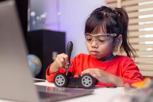 Asia students learn at home in coding robot cars and electronic board cables in STEM, STEAM, mathematics engineering science technology computer code in robotics for kids concept. photo