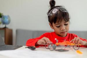 Asia students learn at home in coding robot cars and electronic board cables in STEM, STEAM, mathematics engineering science technology computer code in robotics for kids concept. photo