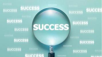 success wording inside of Magnifier glass on light blue background, positive thinking mindset concept. photo