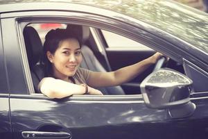 Beautiful girl  is smiling while driving a car photo
