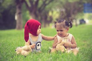 brother calms a crying sister photo