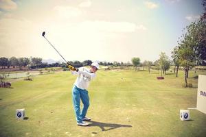 Golfers hit sweeping golf course in the summer.Vintage color photo