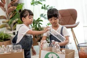 Asian Little girl is separate trash to recycle photo