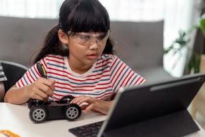 Female Student Building And Programing Robot Vehicle In After School Computer Coding Class photo