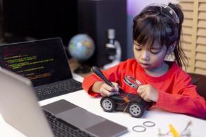 Asia students learn at home in coding robot cars and electronic board cables in STEM, STEAM, mathematics engineering science technology computer code in robotics for kids concept. photo