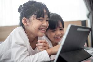 Asian little girl taking class on line and happy for Homeschool Quarantine coranavirus pandemic concept photo