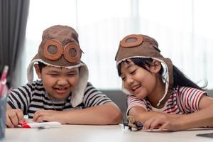 Two children with airplanes in hands photo