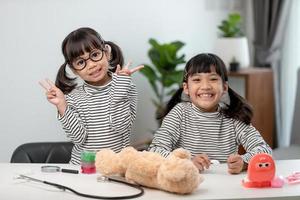 Cute Asian child playing with doctor dentist toy set, child shows how to clean and care for teeth. Dentistry and medicine, photo