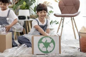 Asian Little girl is separate trash to recycle photo