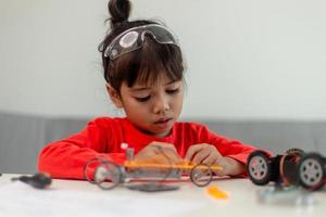 Asia students learn at home in coding robot cars and electronic board cables in STEM, STEAM, mathematics engineering science technology computer code in robotics for kids concept. photo