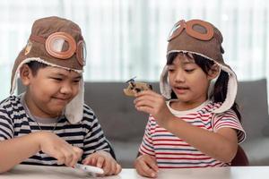 Two children with airplanes in hands photo