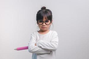 Excited young girl kid holding up big pencils in her hands.Back to school. photo