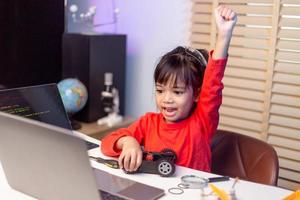 Asia students learn at home in coding robot cars and electronic board cables in STEM, STEAM, mathematics engineering science technology computer code in robotics for kids concept. photo