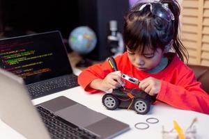 Asia students learn at home in coding robot cars and electronic board cables in STEM, STEAM, mathematics engineering science technology computer code in robotics for kids concept. photo