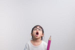 Excited young girl kid holding up big pencils in her hands.Back to school. photo