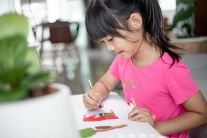 Girl Painting Picture On Table At Home photo