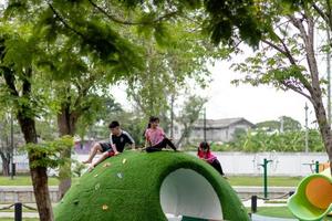 The cute kids are resting in the playground in summer photo