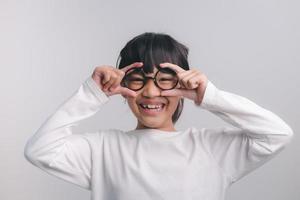 education, school and vision concept - smiling cute little girl in black glasses photo