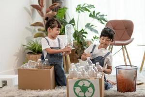 Asian Little girl is separate trash to recycle photo