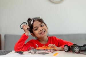 Asia students learn at home in coding robot cars and electronic board cables in STEM, STEAM, mathematics engineering science technology computer code in robotics for kids concept. photo