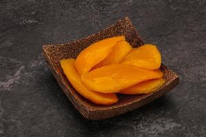 Sweet mango slices in syrop photo