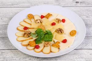 Cheese plate with nuts photo