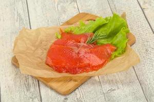 Sliced salmon fillet served rosemary photo
