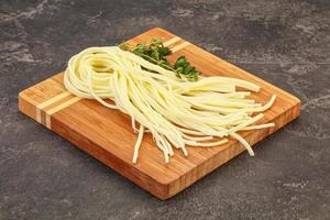 Chechil spaghetti cheese over board photo