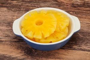 Marinated pineapple rings in the bowl photo