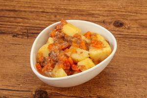 Roasted potato and beef with sauce photo
