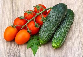 Cucumbers and tomatoes on the branch photo