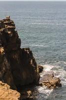 The waves fighting about deserted rocky coast of Atlantic ocean, Portugal photo