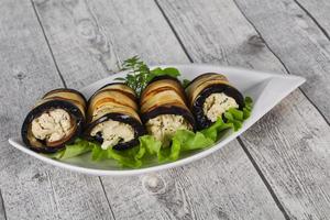 Stuffed eggplant roll with cheese and herbs photo