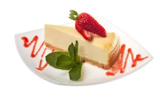 a piece of strawberry cheesecake on whit photo