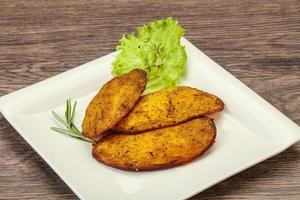 Baked potato with herbs and spices photo